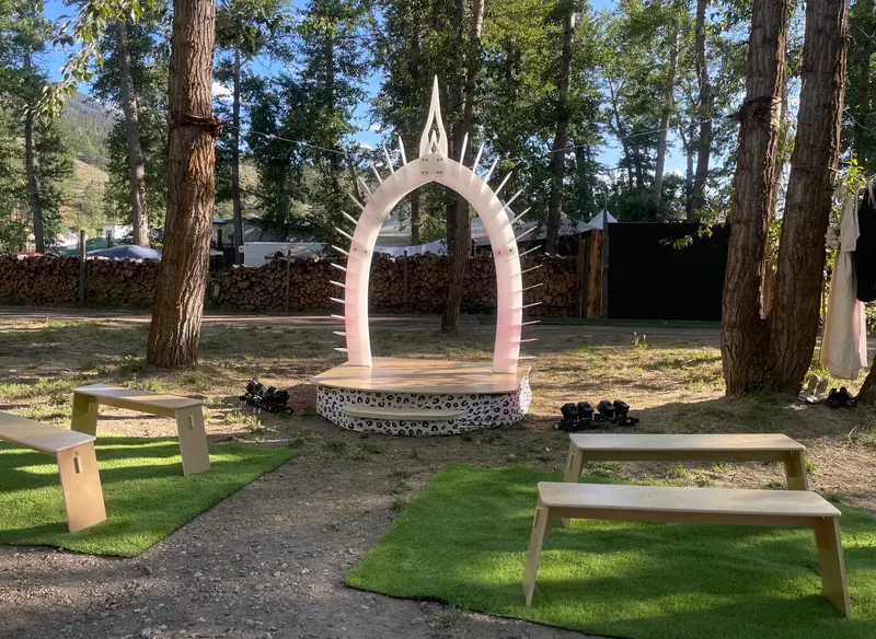 The Wild Union Arch on its platform in daylight, with the festival behind it
